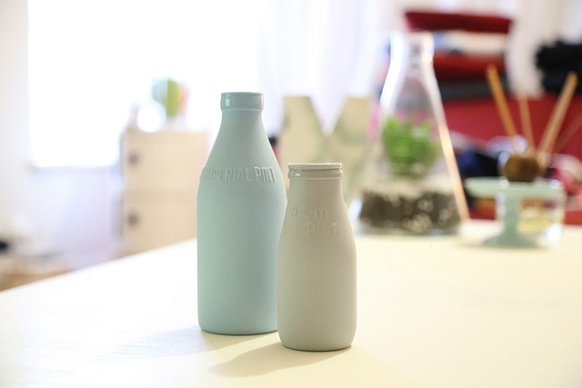 Two opaque bottles containing plant-based milk alternatives