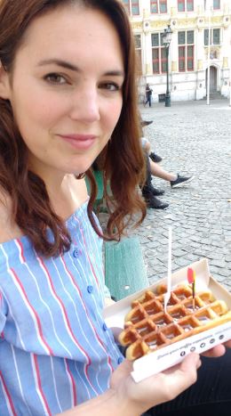 Me holding a freshly baked Belgian waffle in Ghent