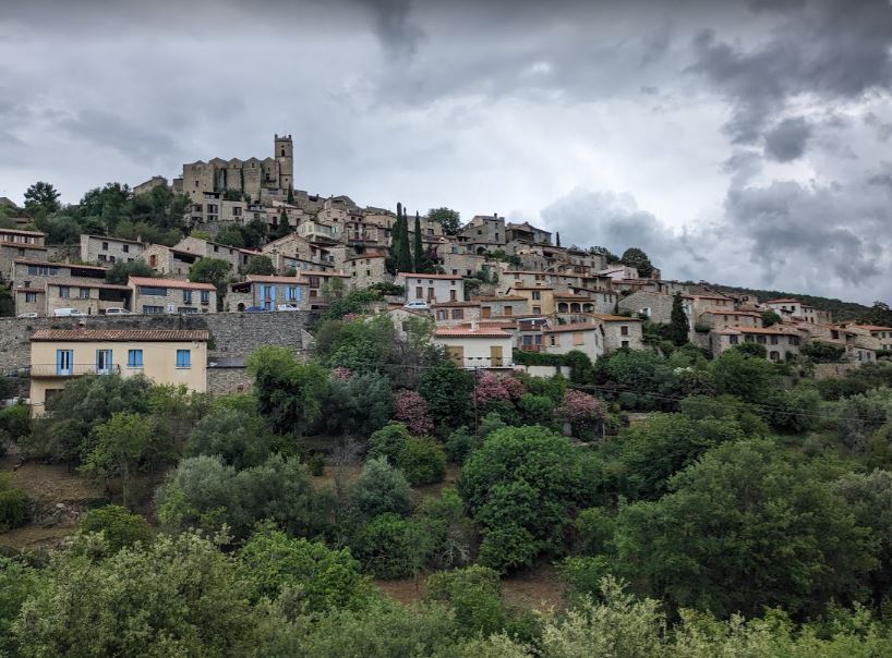 A view of the small town of Eus on a hill with the church right at the highest point