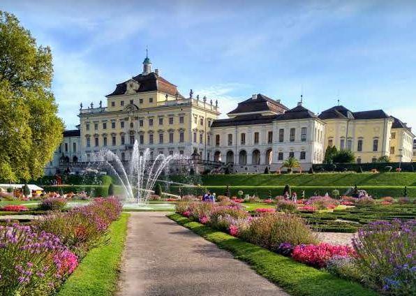 A view of Ludwigsburg Palace from the baroque gardens with a central fountain.