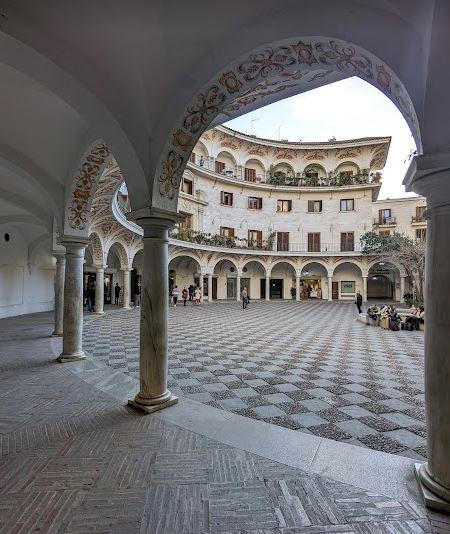 Plaza del Cabildo's semi-circular courtyard from behind one of it's many arches